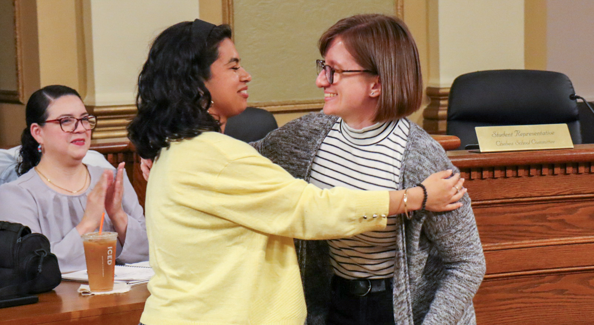 CHS student Rosalia Hernandez embraces teacher Monika Sulima at Chelsea City Hall